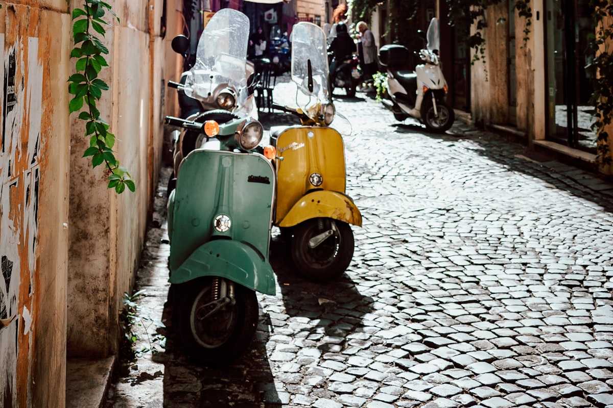 Vintage scooters parked on a cobblestone street in Rome