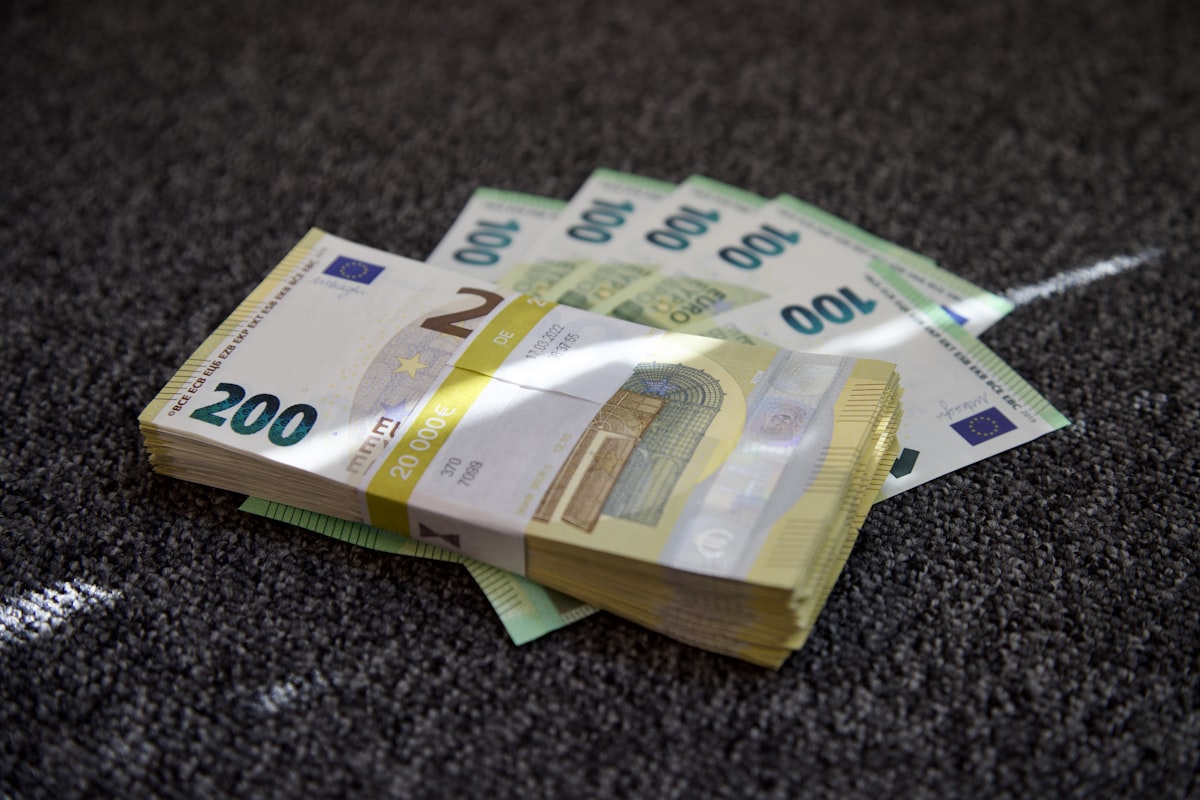 Euro banknotes and coins spread out on a surface