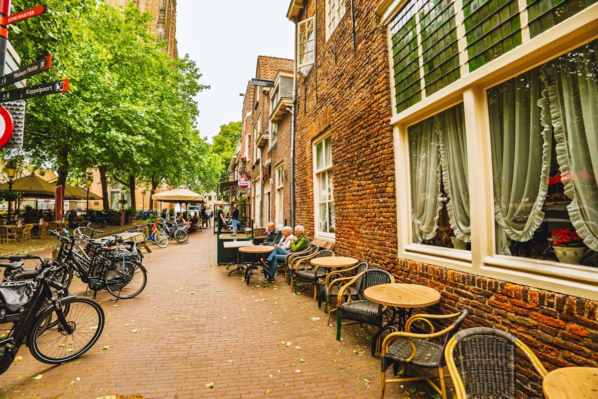 Outdoor cafe seating along a historic European street