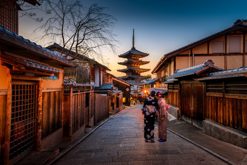 Traditional street in Kyoto at sunset with pagoda in background